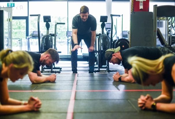 coach exercise with others in gym