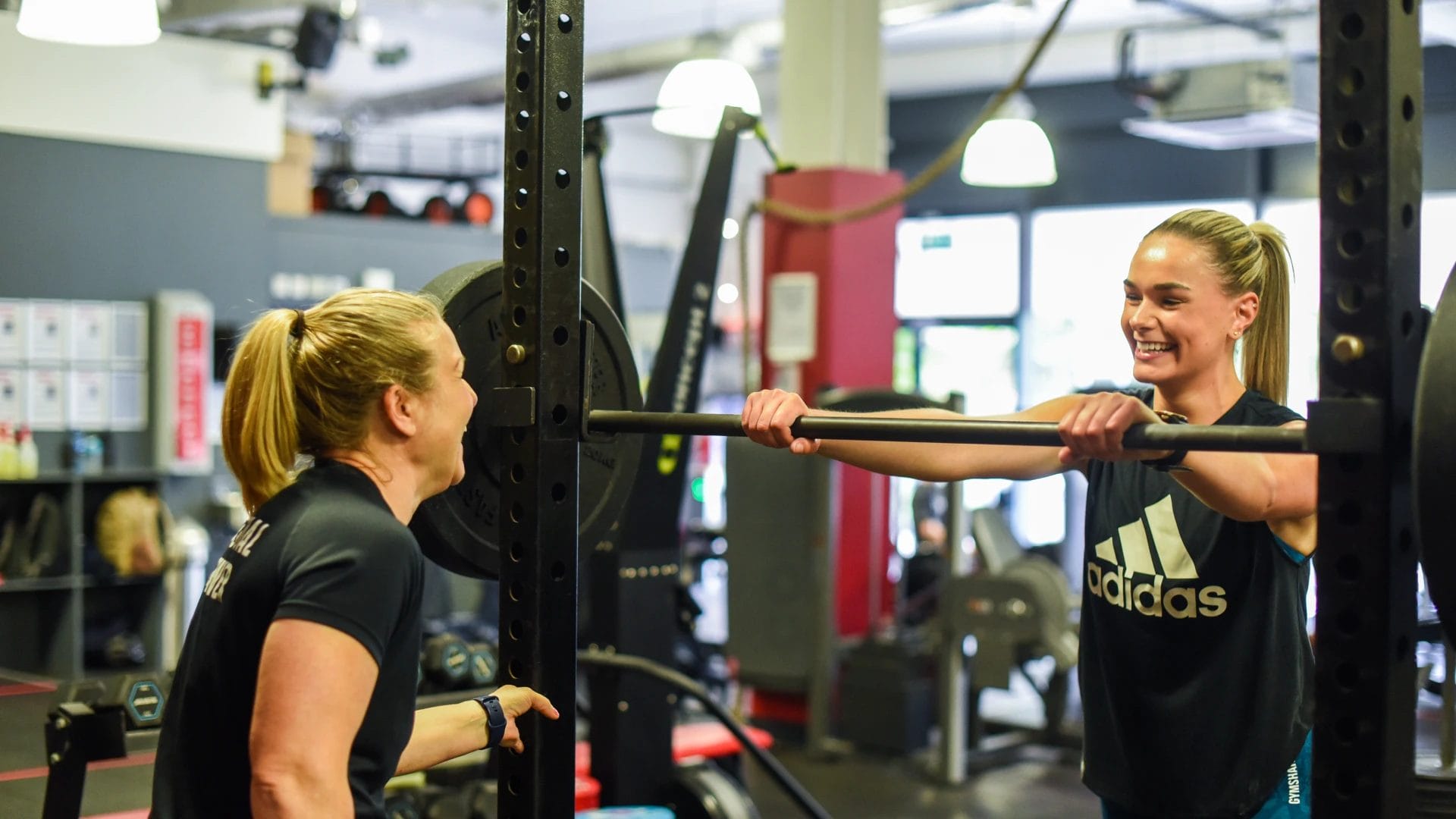 two girls exercise and smile
