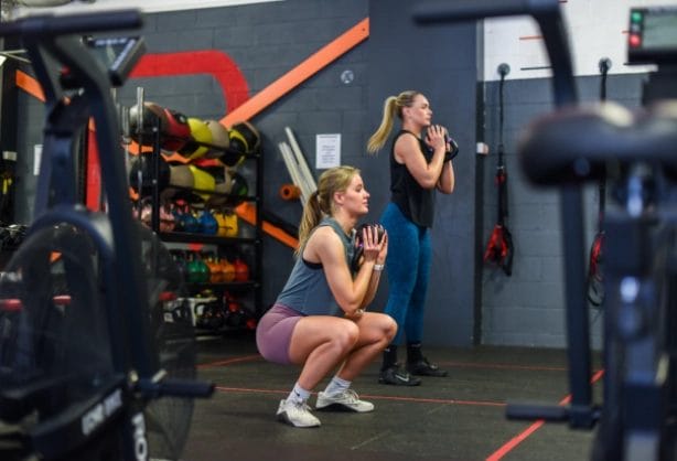 two girls with kettlebell