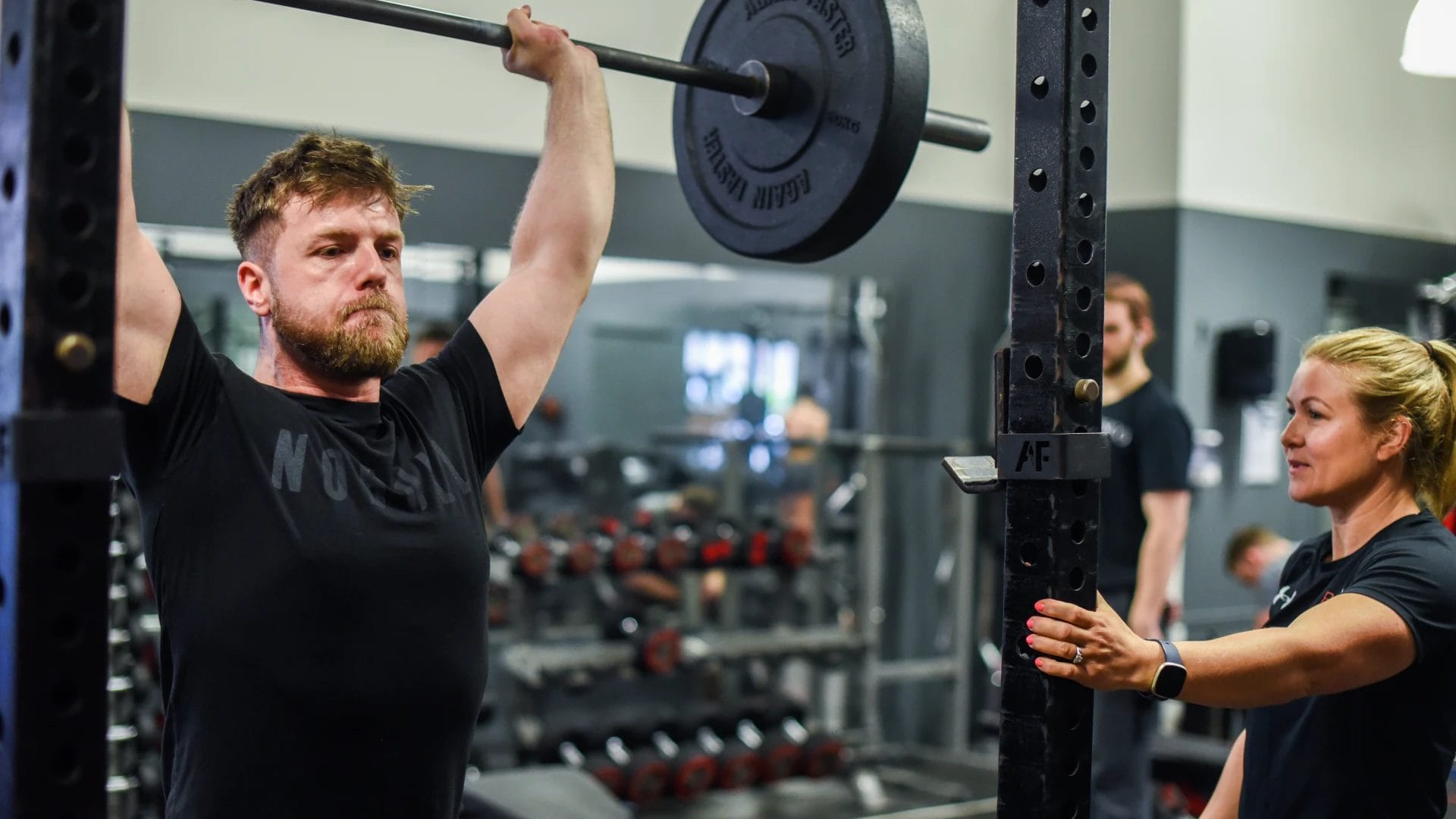 one woman and man who lift weight